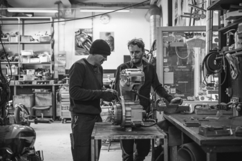 Nicholas and Per working on a Harley motor